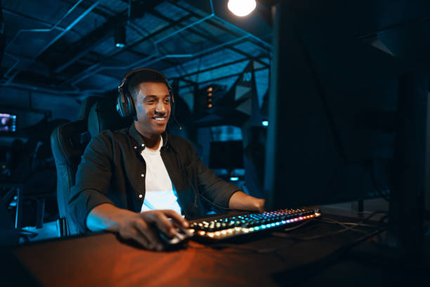 istock A man in headphones sits at a computer and actively reacts to the game. 2024971221