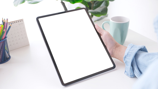 Hand using digital tablet with blank screen for mock up, template, people technology and lifestyle