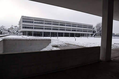 The Kantonsschule Enge (high school) also named Kantonsschule Freudenberg. The image shows the main building captured during winter season. The building represents an important architecture of the 20th century in switzerland.