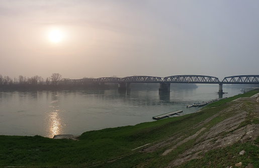 Panoramic view from the riverbank of the Po river in Cremona near the famous old iron bridge