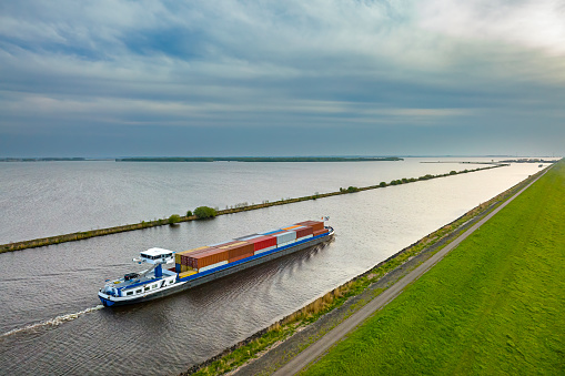 Stade, Germany – May 8, 2021: CMA CGM Montmartre, one of the  largest container vessels powered by Liquid Natural Gas, on Elbe river heading to Hamburg,
