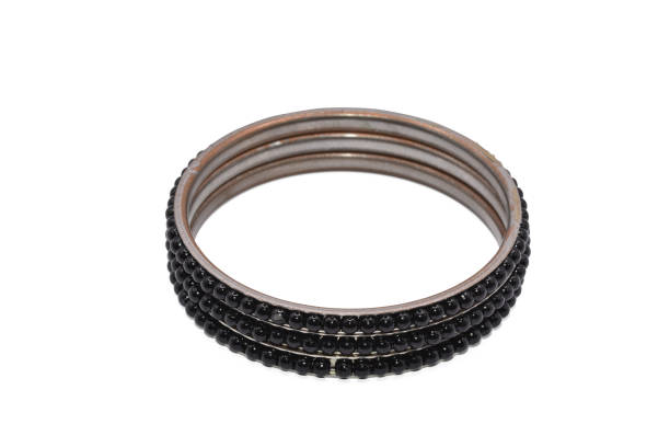 The old bangle jewelry  has silver color isolated on white background,decorated with gems,made with metal,macro  photo,has path