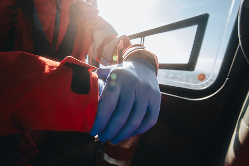 Close-up hands of prepared doctor in surgical gloves inside helicopter of emergency medical service. Themes rescue, help and hope.