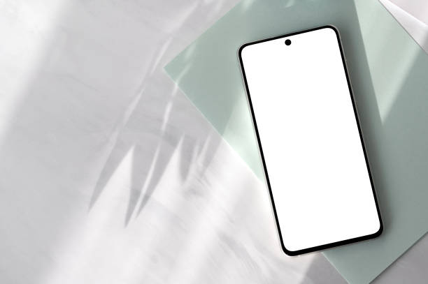 istock Smartphone with empty screen mockup on pastel sage green paper and neutral gray marble desk background with aesthetic floral natural sun light shadows, elegant spring business branding template 2025038211