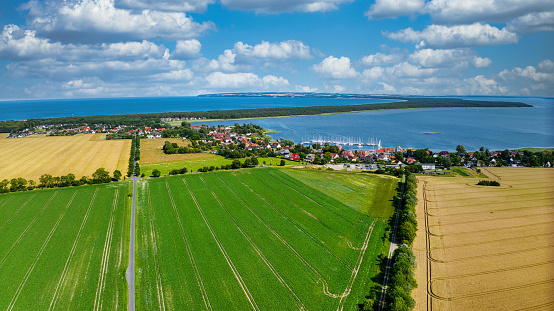 View over the beautiful island of Rügen in autumn. Landscape, sea, sky, harbor, town, grain fields. Baltic Sea. Germany