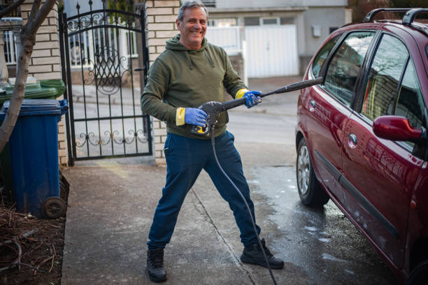 istock DIY, smiling man washes car by himself 2025050578