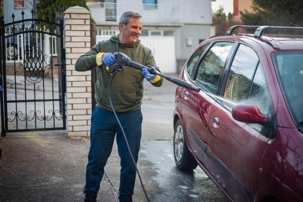 DIY, smiling man washes car by himself