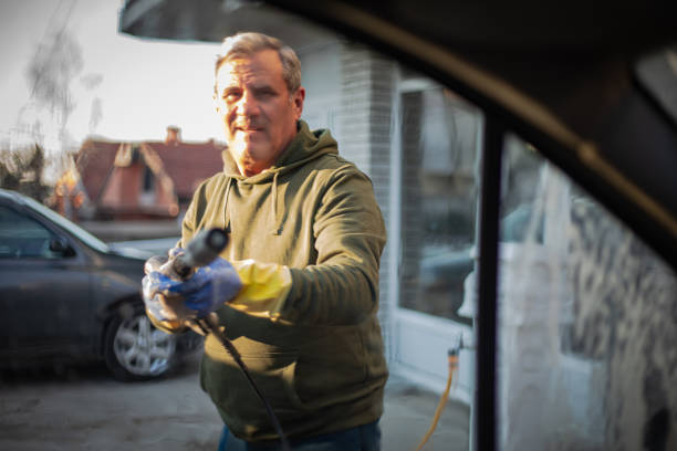 istock DIY, smiling man washes car by himself 2025051093