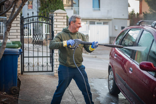 istock DIY, smiling man washes car by himself 2025051116