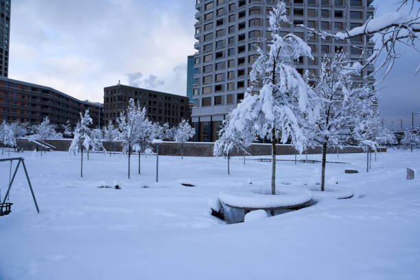 Fountain and advent stalls of Zrinjevac Park in Zagreb in cold winter with snow and sunshine, Croatia, Europe