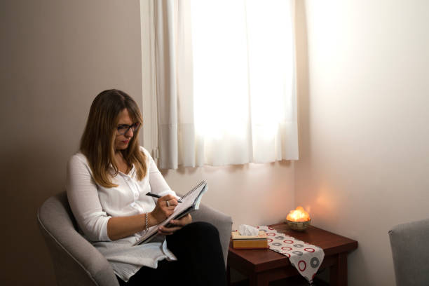 istock Psychologist in her consulting room thinking and writing in a notebook. 2025055975