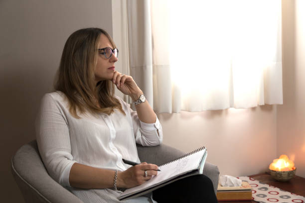 istock Psychologist in her consulting room thinking and writing in a notebook. 2025055981