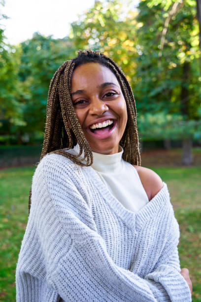 istock Happy young black woman, standing outdoors in a public park looking at camera smiling. 2025069740