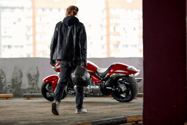 istock Handsome rider boy with beard and mustache in black leather biker jacket sit on classic style cafe racer motorbike on rooftop at sunset. 2025081195