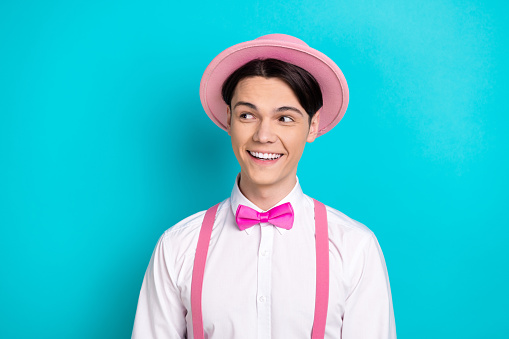 Photo portrait of pretty young male look empty space cheerful dressed stylish pink outfit isolated on aquamarine color background.