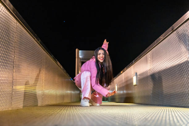 istock Free style dancer performing sitting on a bridge at night 2025092734