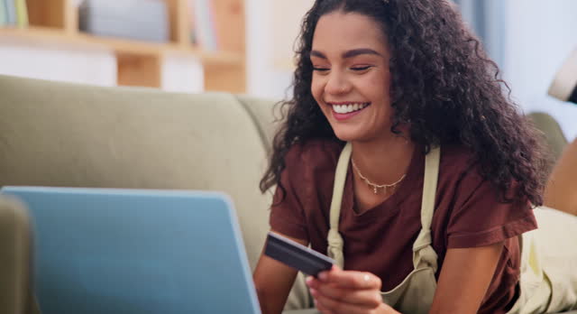 Woman, laptop and happy on couch with credit card, discount and connection with digital payment for online shopping. Person, relax or pc for fintech on iot or internet banking in home with technology