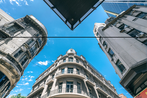 Upward view of European-inspired architecture in Buenos Aires under a clear blue sky.