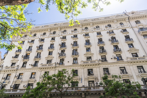 Elegant historical building facade in leafy Buenos Aires with grand European-style architecture.
