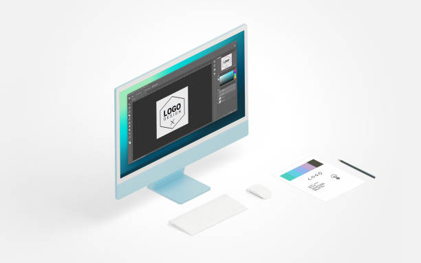 Logo creation process on computer display, alongside paper sketch and pen in isometric view, blending digital and traditional design methods