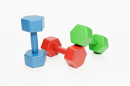 Colorful dumbbells on a white background.Composition with clipping path and copy space.. Stock photo
