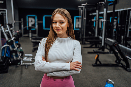 Portrait of a young female fitness trainer at the gym