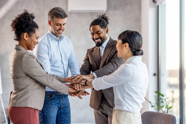 istock Coworkers with stacked hands at the office 2025175022
