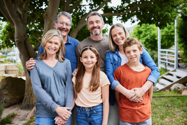 istock Smiling multi-generation family standing together in their yard 2025184713