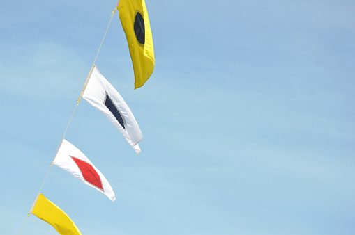 maritime flags against blue sky