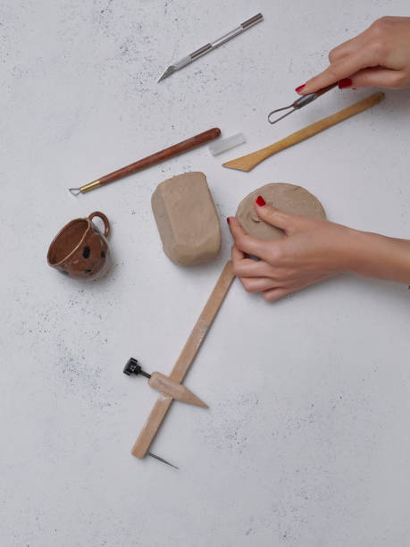 istock Making ceramic, women's hands and tools on the decorative table style background, up view. 2025207007