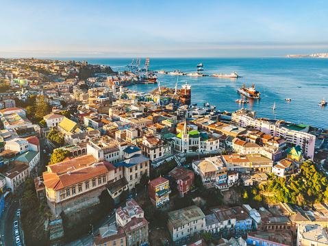 drone view over old town Valparaiso – Chile at late afternoon, the freight harbor in the background