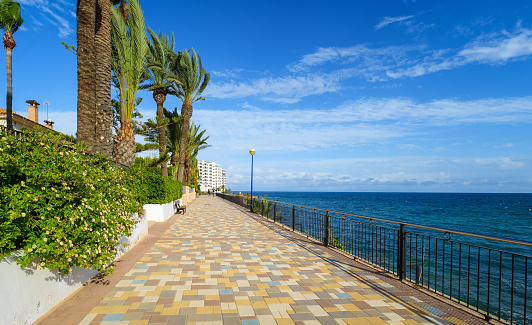 Promenade of Punta Prima on the coast of Mediterranean sea in Torrevieja, Alicante, Spain. Coast of the Costa Blanca. Travel and vacation destinations.