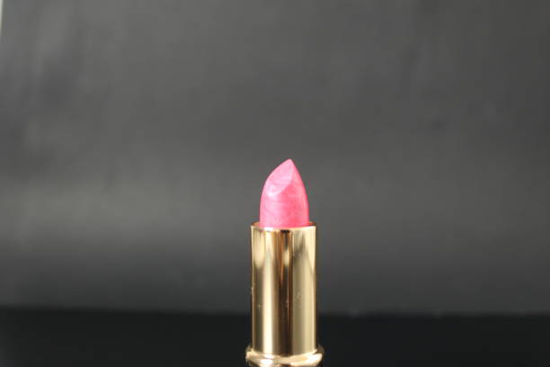 istock Pink lipstick in black tube on black background with mets for copy space text 2025232059