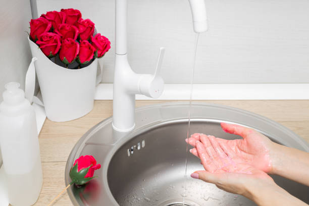 istock man washes his hands with soap rose petals 2025238766