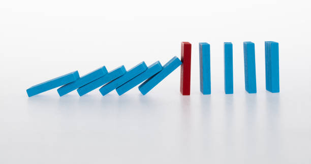 istock Red wooden block stop other falling dominos 2025248933