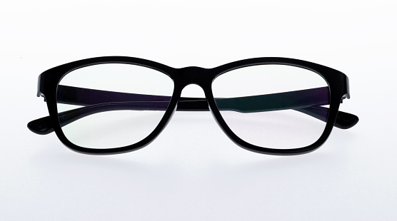 female hands are wiping spectacles with a microfiber fabric