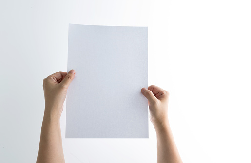 Human hand holding blank paper on white background