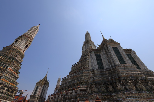 Wat Arun, seen from the bottom up, sees the blue sky. Wat Arun is an iconic landmark of Bangkok, Thailand.