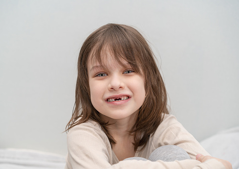 Little girl 7-8 years old has lost milk teeth. Loss of milk teeth, have fun