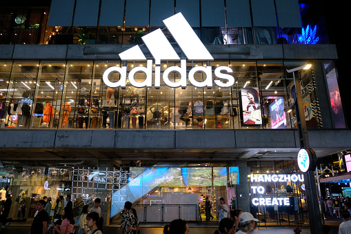 Hangzhou,China-July 15th 2023: facade of large adidas flagship retail store at night