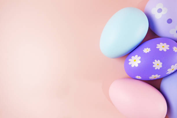 Pastel colorful Easter eggs on pink background stock photo copy space