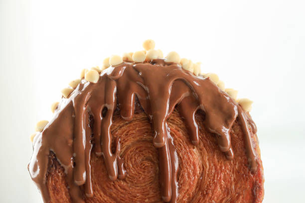 Close Up Croissant Bomboloni or Cromboloni with melted Chocolate and White Chocolate Chips, Isolated on White