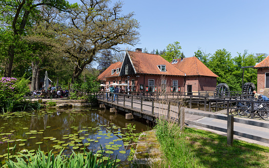 Locals and tourists walk on the quay of the picturesque town of Hindeloopen in Friesland.