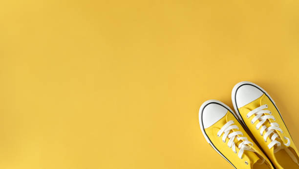 istock Yellow Sneakers on Yellow Background. Top View. Perfect for Spring and Summer. 2025285143