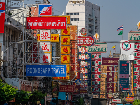 Shop signs and Traffic In the morning of chinatown Thailand, Yaowarat is a major of gold trading market in Bangkok. on December 16, 2022 in Bangkok Thailand.