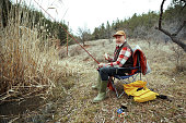 Senior fisherman posing for a shot while enjoying day in nature