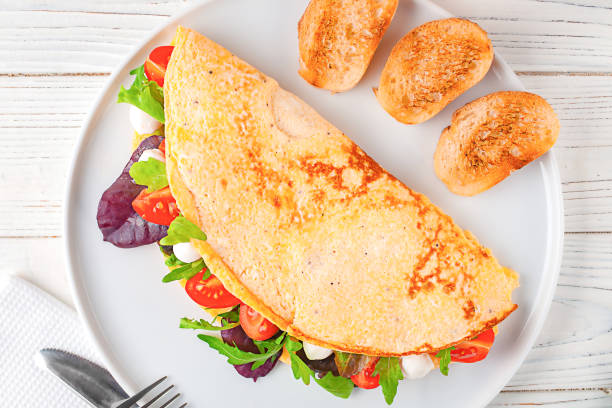 istock Breakfast omelette with cherry tomatoes and mozzarella cheese on a platter 2025302159
