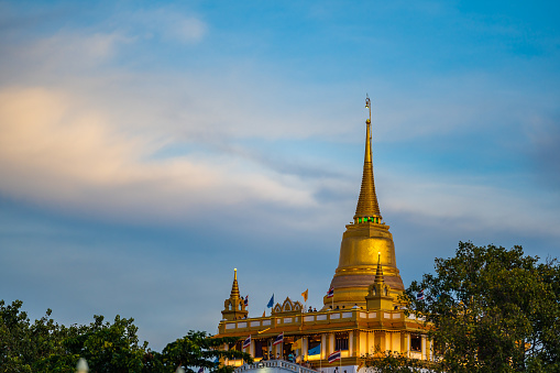 Beautiful sunset at Golden mountain (phu khao thong), an ancient pagoda at Wat Saket temple. The famous destination in Bangkok, Thailand.