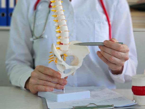 istock Doctor shows on spine place where intervertebral hernia appears concept 2025374111