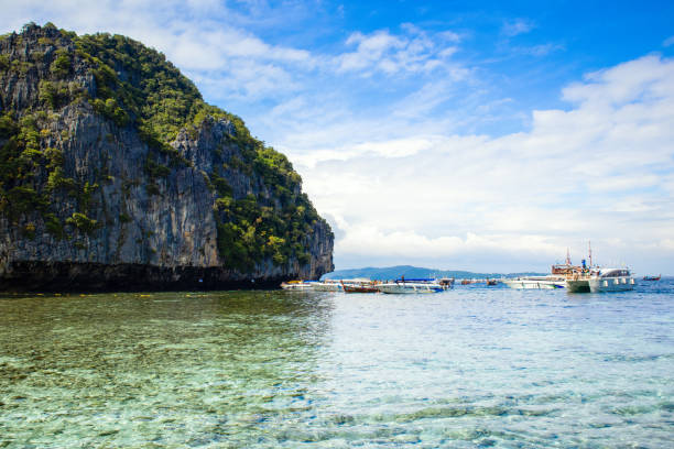 Phi Phi, Thailand - November 23, 2023: Cruise boats and yachts near Phi Phi islands - one of the most famous places with paradise views and green rocks
